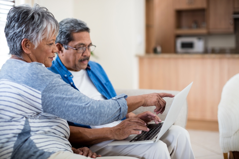 Older couple looking at laptop, considering retirement income plan