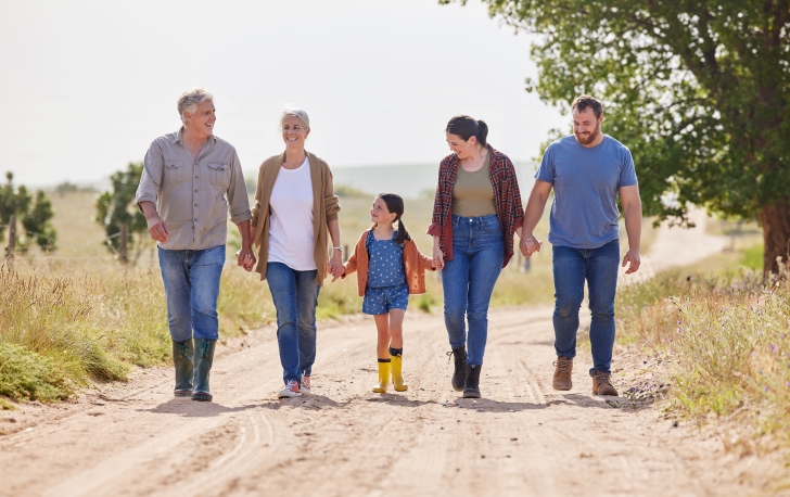 Multigenerational family walking together on a farm